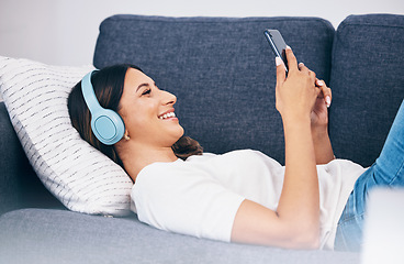 Image showing Headphones, phone and sofa woman or student with meme video, internet chat and music for mental health and relax. Smartphone of person on couch streaming, listening to audio or a funny podcast online