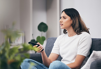 Image showing Woman confused watching tv, streaming with remote control and relax at home, thinking or vision problem with squint. Entertainment with leisure in living room and confusing television show or film