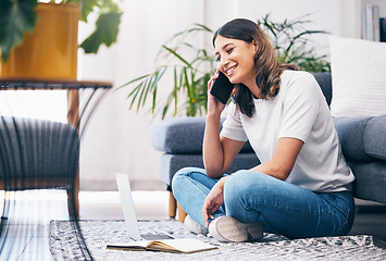 Image showing Woman, phone call and laptop with notebook in the living room by sofa in remote work or studying at home. Happy female freelancer in conversation or discussion on smartphone and computer on the floor