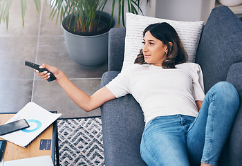 Image showing Television, relax and a woman on a sofa in the living room of her home streaming a subscription service. Watching tv, channel surfing and comedy with an attractive young female lying in her lounge