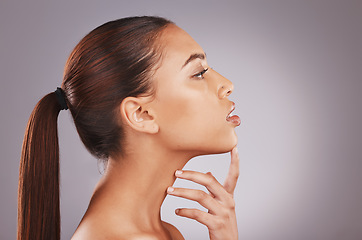 Image showing Black woman neck, face profile and skincare with antiaging aesthetic for wellness and self care. Isolated, gray background and studio with person with healthy dermatology feeling skincare glow