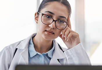 Image showing Tired doctor, laptop or woman medical student reading online credit debt, email or university outstanding bills. Financial crisis, sad or nurse face on tech for hospital payment agenda or compliance