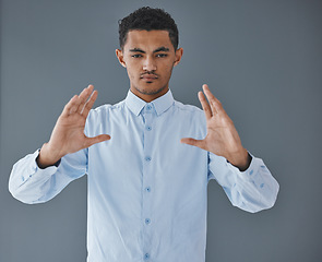 Image showing Product placement, space and hands of a man on a wall for logo marketing and presentation. Sales, showing and serious employee advertising a service, commercial or promotion on a grey background