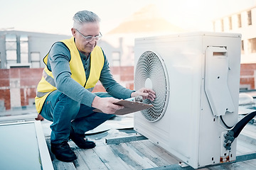 Image showing Engineer on rooftop, air conditioning and technician with clipboard, maintenance or repair machine. Male, worker or handyman with document, checklist or confirm working fan hvac for quality assurance