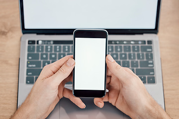 Image showing Hands, phone and laptop on mockup screen for networking, social media or mobile app at office desk. Hand of person with display on smartphone for online advertising, branding logo or marketing