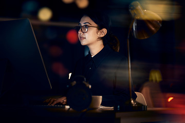 Image showing Serious, woman and night business on computer for planning, research or strategy in office. Female working overtime on desktop technology, online or network of internet analytics, seo vision or focus