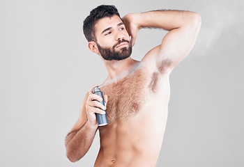 Image showing Deodorant, beauty spray and man in studio for hygiene, fresh scent or sweat control. Male model spraying armpit for body odor, smell and cleaning cosmetics, shower product and skincare on background