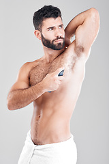 Image showing Deodorant, spray and man in studio grooming for hygiene, fresh scent or sweating smell. Male model spraying armpit of body odor, beauty cosmetics and cleaning skincare of bottle product on background