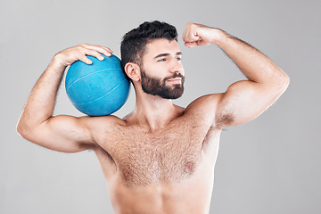 Image showing Sport, fitness and man with ball flexing arm, topless and isolated on grey background. Exercise, motivation and sports goals, strong bodybuilder with workout mindset for training in studio with smile