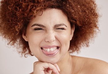 Image showing Black woman face, wink and beauty with smile, funny facial expression with skincare and natural hair on studio background. Healthy skin, cosmetics and teeth, dermatology and wellness in portrait