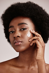 Image showing Skincare, face and portrait of black woman with lotion, afro and advertising luxury skin care with collagen product promotion. Dermatology, cosmetic and facial for model isolated on studio background