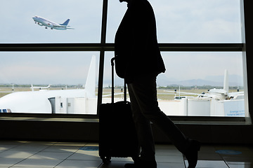 Image showing Airport, travel and silhouette person walking to airplane, flight booking or transportation for world trip. Suitcase luggage, plane departure and profile man on holiday, vacation or business journey