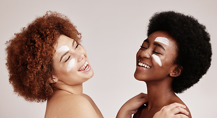 Image showing Cream, face treatment and girl friends with black women and happiness for skincare and beauty in studio. Wellness, people and spa aesthetic with lotion and moisturizer for facial and cosmetic product