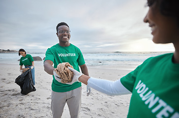 Image showing Teamwork, help and recycling with people on beach for sustainability, environment and eco friendly. Climate change, earth day and nature with volunteer and cleaning for charity and community service