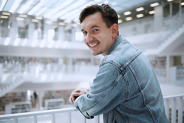 Image showing College, education and portrait of a man in the library for learning, research and reading. Smile, future goals and happy student at university for studying, knowledge and scholarship for school