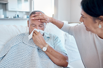 Image showing Covid, tissue and healthcare with a man sick at home with his wife taking care of him in the living room. Medical, blowing nose and fever with a senior woman looking after her husband in a house