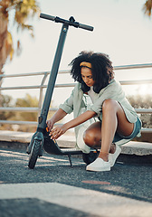 Image showing Black woman, ebike and sustainable travel in city, adventure and fix or park scooter outdoor. Eco friendly transportation, freedom with carbon footprint and transport in urban street in Miami