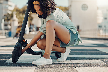 Image showing Black woman, scooter and eco friendly travel in city, adventure and fixing the wheel of ebike outdoor. Sustainable transportation, freedom with carbon footprint and transport in urban street in Miami