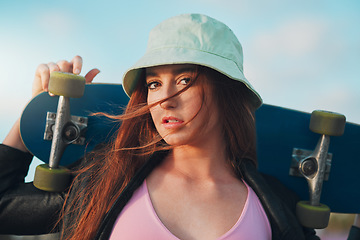 Image showing Attitude, skateboard and portrait of woman in city for freedom, sports and relax lifestyle. Training, fitness and summer with face of girl in urban town enjoying adventure, wellness and vacation