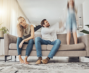 Image showing Family life stress, parents and child, chaos at home and energy, motion blur and burnout headache. Kid jump on couch, woman has migraine and man calming girl, hyperactive with ADHD and mental health