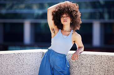 Image showing Portrait, fashion and armpit hair with a black woman in the city on a bridge, looking relaxed during summer. Street, style or urban and a natural young female feminist outside with an afro hairstyle