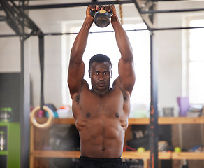 Image showing Black man, bodybuilder and kettlebell for fitness in gym, arm muscle training, portrait and weightlifting exercise. Biceps, strong and bodybuilding, focus and serious with commitment to workout