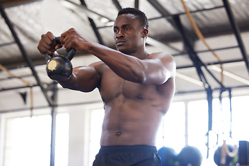 Image showing Black man with kettlebell in gym, fitness and power with arm muscle training, bodybuilder and weightlifting exercise. Biceps, strong and bodybuilding, focus and serious with commitment to workout