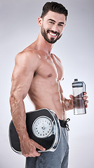 Image showing Fitness, portrait or man with weight scale or water bottle in studio for training, exercise or workout for body goals. Healthy model, energy or happy sports athlete with smile, motivation or wellness