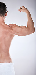 Image showing Fitness, health or strong man flexing muscle after exercise, training or gym workout for body goals. Sports motivation, back view or healthy bodybuilder athlete with biceps muscles isolated in studio