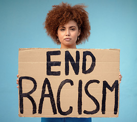 Image showing Poster, political and portrait of a woman in a studio for a protest for racism, equality and human rights, Freedom, social justice and female from Mexico with a sign for a rally by a blue background.