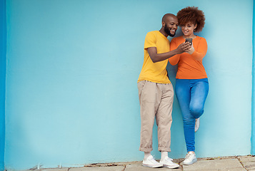 Image showing Friends, wall and smartphone for social media, outdoor and connection in street, mockup and happiness. Black man, casual woman and cellphone for communication, share photos and smile in city or town