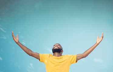 Image showing Studio space, advertising and open arms of black man for announcement, news and information on blue background. Marketing, mockup and excited male for promotion, product placement and discount deal