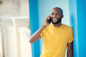 Image showing Black man, fashion or phone call on blue background or city wall for talking, communication or social networking app. Smile, happy or student on mobile technology in trendy, cool or stylish clothes