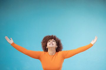 Image showing Advertising, studio space and open arms of black woman for announcement, news and sale. Marketing, discount mockup and girl present, show and display copyspace for promotion on blue background