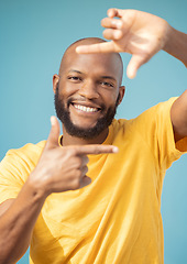Image showing Hands, frame and portrait of black man on blue background for profile picture. Face, happy guy and finger framing for perspective, selfie and vision of happiness, smile and photography sign in studio