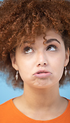 Image showing Comic, thinking and sad face of woman on blue background upset, unhappy and looking up in studio. Emotion mindset, mental health and emoji facial expression of girl thoughtful, attitude and depressed