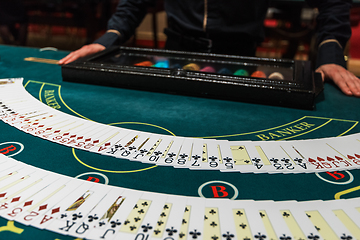 Image showing Professional croupier during cards