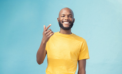 Image showing Black man, portrait or hand gesture on blue background, isolated mockup or wall mock up in cool story, hey or attention. Smile, happy face or student in trendy, stylish or fashion clothes on backdrop