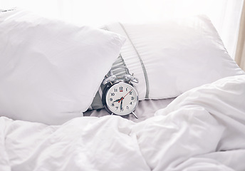 Image showing Time, waking up and alarm clock on a bed with no people for punctual, sleeping and hour management. Empty, bedroom and vintage timer for routine, sleep and rest schedule, snooze and resting on mockup