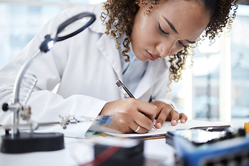 Image showing Science, research and writing with a black woman doctor working in a laboratory for innovation or breakthrough. Notebook, data and checklist with a female scientist at work on a report in a lab