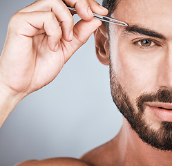 Image showing Portrait, man and tweezers for eyebrows, cosmetics and morning routine with guy on grey studio background. Face care, male and gentleman with skincare, beauty and hair removal for grooming and facial