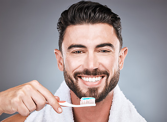 Image showing Brushing teeth, studio portrait and man with toothbrush for dental wellness, healthy lifestyle or mouth care. Happy face, male model and oral cleaning of fresh breath, smile and happiness on backdrop