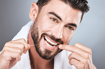 Image showing Mouth floss, tooth and man in studio for wellness, healthy body care or hygiene on background. Teeth, flossing and guy with dental cleaning for facial beauty, fresh breath or happy bathroom cosmetics