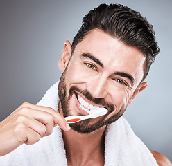 Image showing Brushing teeth, studio portrait and man with toothbrush, dental wellness and healthy mouth care. Happy face, male model and oral cleaning for fresh breath, smile and facial happiness with toothpaste