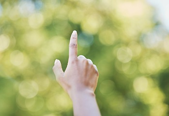 Image showing Hand, index finger and pointing in nature, outdoors or at park at something. Direction, bokeh and hands point up for gesture, signal or sign language, counting fingers or emoji, mathematics or timer.