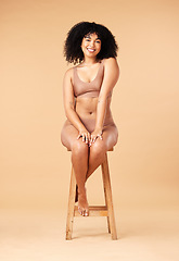 Image showing Body positive, beauty and black woman sitting on a chair for skincare and self care isolated in a studio brown background. Plus size, portrait and natural model smile, happy and glow due to cosmetic