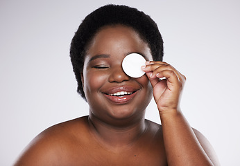 Image showing Beauty, skincare and plus size with a model black woman in studio on a gray background for exfoliation. Face, skin and cotton swab with an attractive young female posing to promote natural health