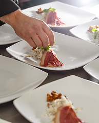 Image showing Chef decorating appetizer plate