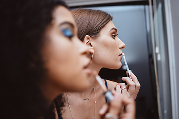 Image showing Women, friends and makeup at mirror in bathroom for beauty, diversity or cosmetics in night together. Black woman, girl and model with lipstick, dark aesthetic and creativity for cosmetic application