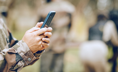 Image showing Soldier, hands and phone texting in communication for social media, networking or conversation at war. Hand of person holding mobile smartphone on app in the army for discussion, chatting or contact